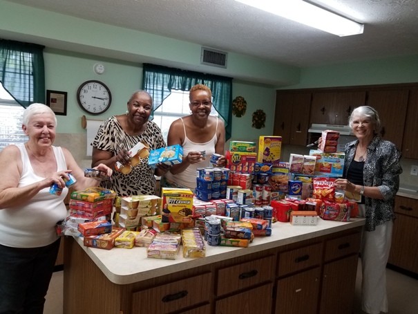 Arlington Women's Club members Pat McBride, Emma Toomer, Sheila Brown-Jefferson and Lu Coberly gather non-perishable food for veterans in need at the Clara White Mission in Jacksonville on June 22. The meal was donated by Angie’s Subs in Jacksonville Beach. Prepackaged, non-perishable food for the veterans’ future meals was collected by the organization Turning Points in America. In addition to the Arlington Women’s Club, VFW 7909, the Ponte Vedra American Legion, the Ponte Vedra Tea Party, the Benghazi Tribute Team and numerous individual donors also provided stacks and stacks of prepackaged food servings.